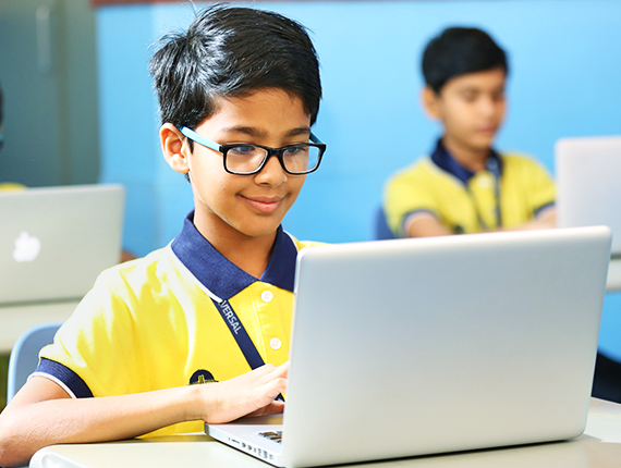 Student learning digitally on laptop at Universal High School